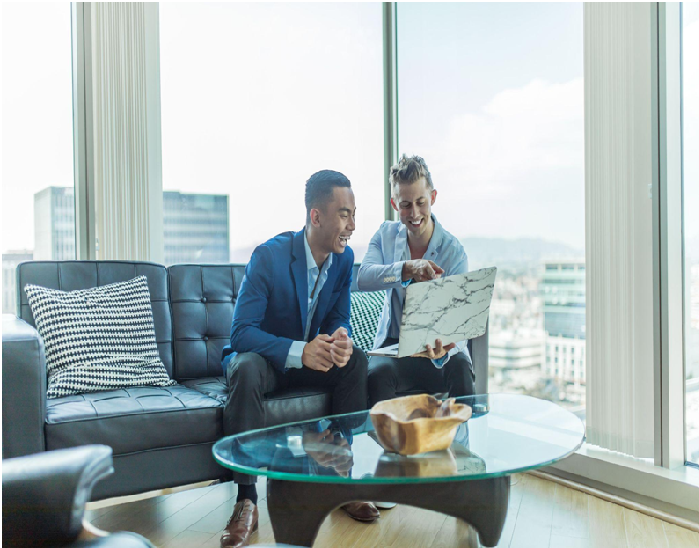 Business partners look at their computer, similar to a consultation with Darren and Mike